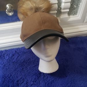 Hat with fur ball tan and black leather